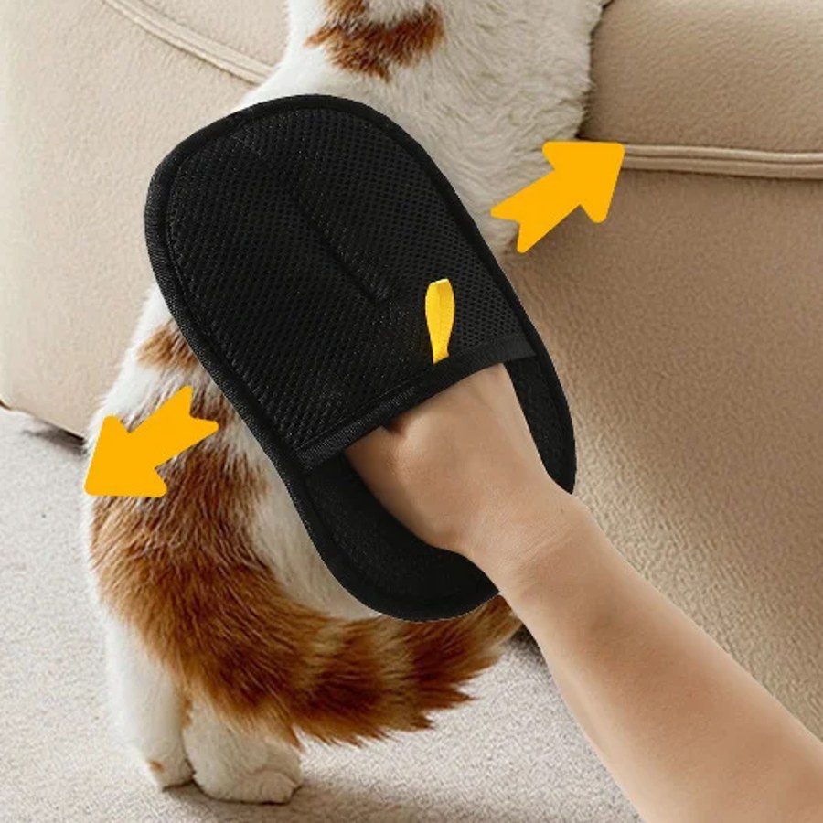 Pet hair remover glove used on a sofa